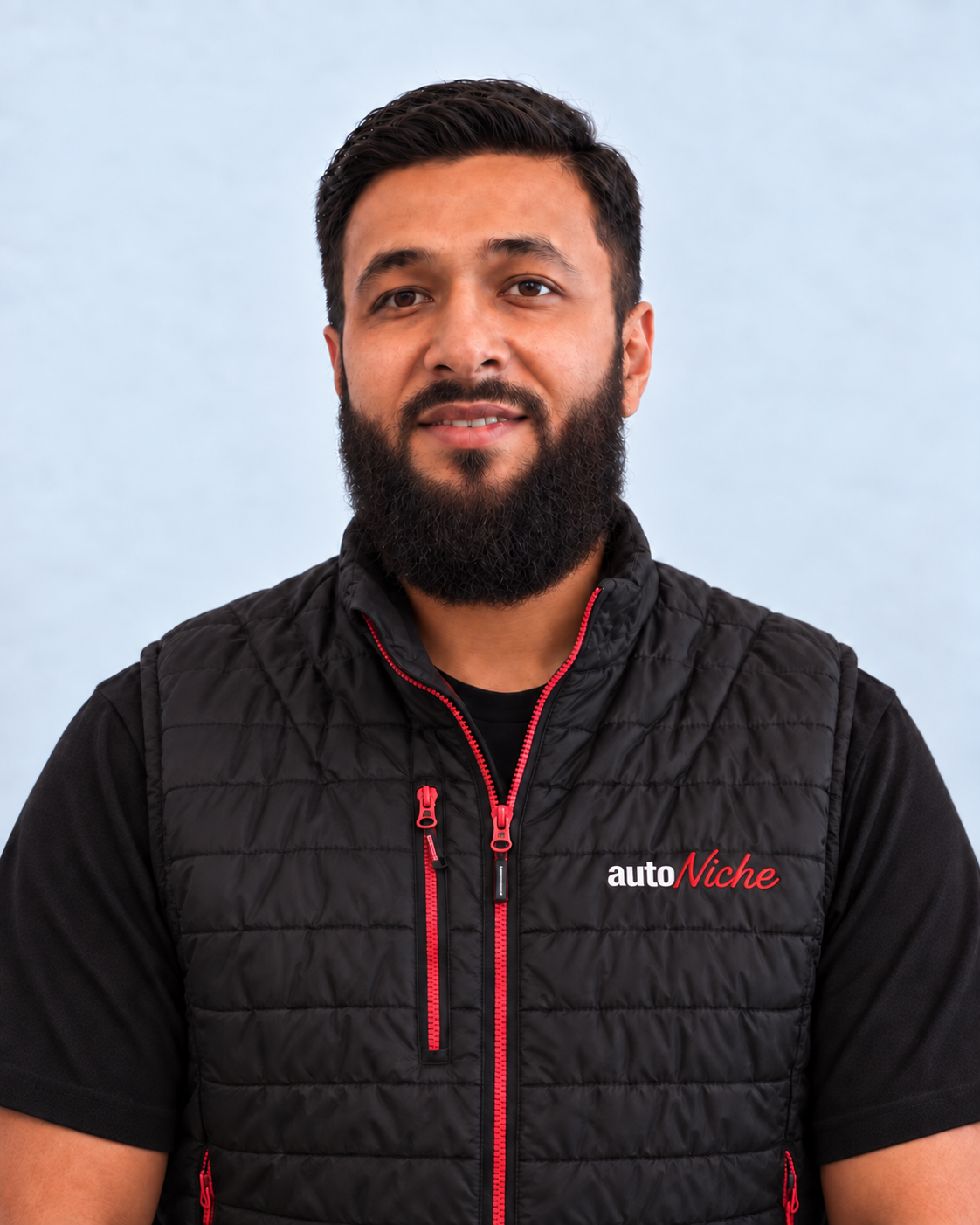 Mohammed, owner of AutoNiche, wearing an AutoNiche jacket