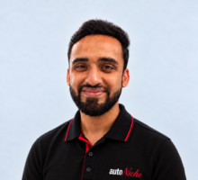 Murtaza, AutoNiche Service Advisor, in an AutoNiche polo against a light studio background